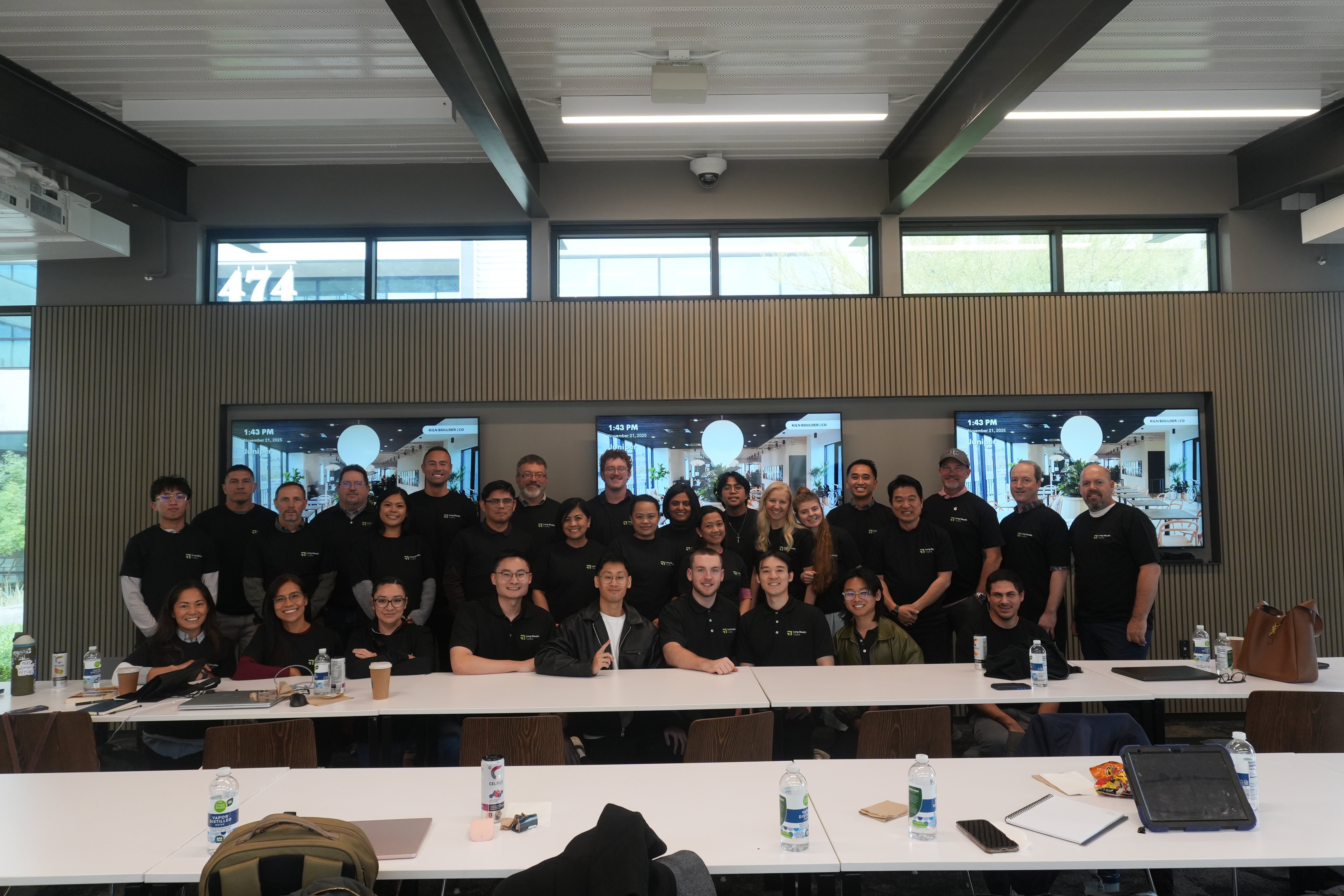 Long Wealth Capital community event with members and team in conference room