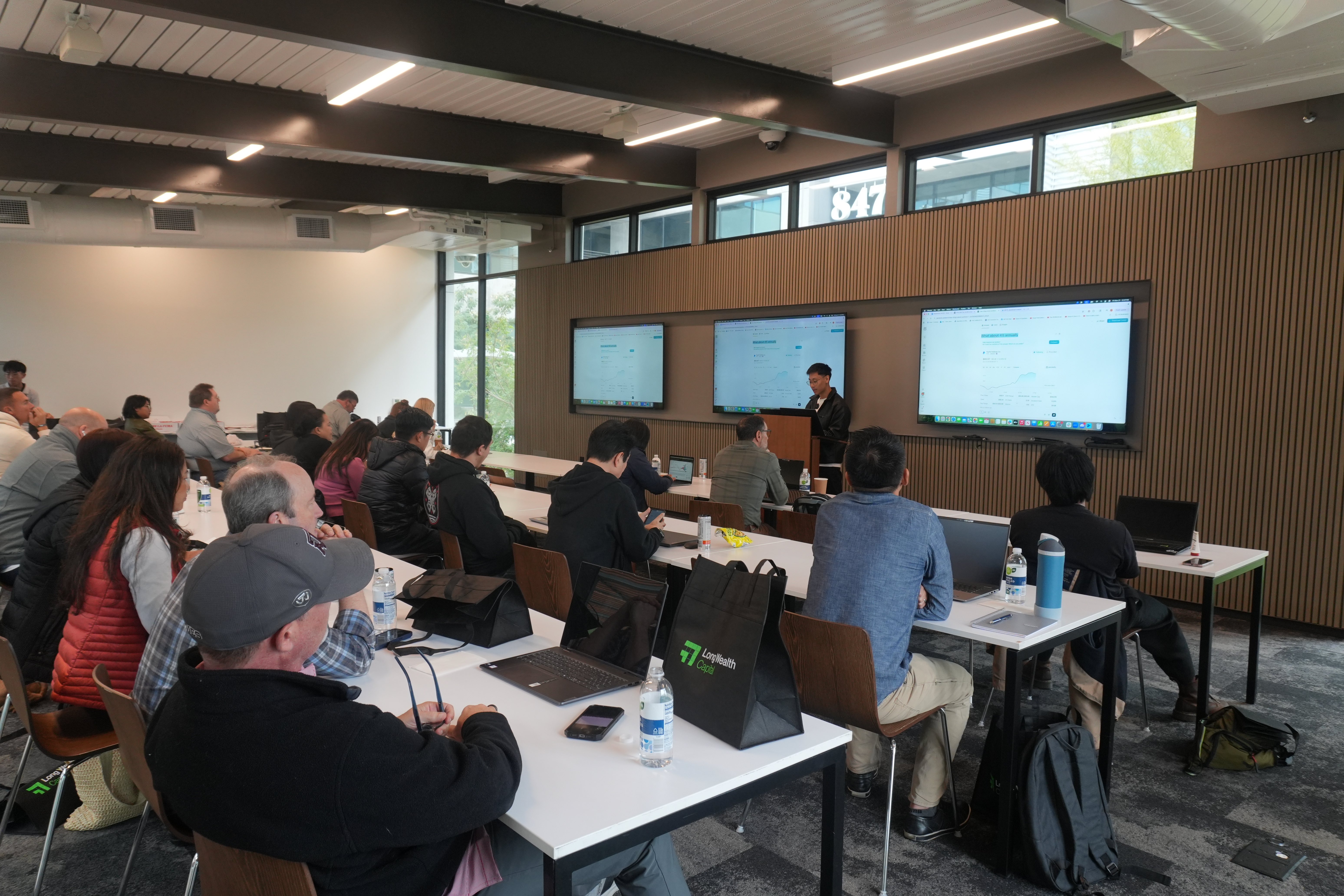 Long Wealth Capital training session with members learning in classroom setting